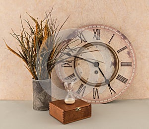 Clock and Hourglass with Floral Arrangement