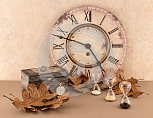 Clock, Hourglasses, Wristwatch, and Pocketwatch with Autumn Leaves