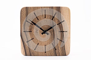 Clock made of wood. Clock face in loft style. Designer Scandinavian watch. On a white background