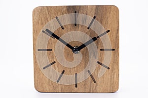 Clock made of wood. Clock face in loft style. Designer Scandinavian watch. On a white background