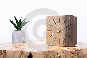 Clock made of wood. Clock face in loft style. Designer Scandinavian watch. On a white background