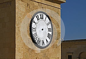Clock with no hands on a tower in Malta