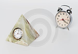 Clock from onyx and alarm clock, on white background