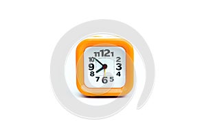 Clock orange with white backdrop.Orange clock on a white backgr