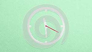 clock paper set on a green background.stop motion