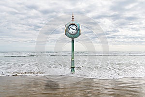 A clock in rising sea waters depicting the metaphors of time and change