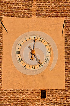 A clock with Roman numerals on a brick wall