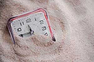 Clock on sand beach. conceptual for time period