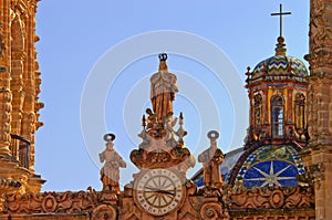 Clock on Santa Prisca church in Taxco, Mexico photo