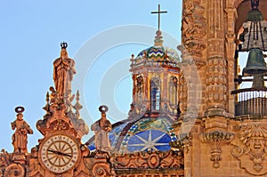 Clock on Santa Prisca church in Taxco, Mexico photo