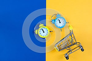 Clock and shopping basket on a yellow-blue background