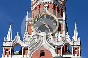 Clock on the Spasskaya Tower of the Moscow Kremlin against the blue sky on a summer sunny day. Moscow, Russia