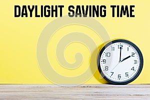 Clock on table with Daylight Saving Time message