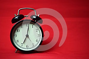 Clock ticking to 7 o`clock on the red background