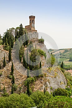 The Clock Tower of Brisighella among the cupressuses vertical