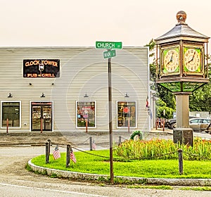 Clock tower in center of town with bar and grill