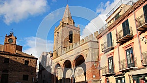 clock tower, church and habitation building in castelbuono in sicily (italy)