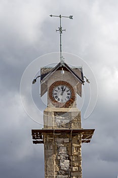 Clock tower on a cloudy sky background close-up