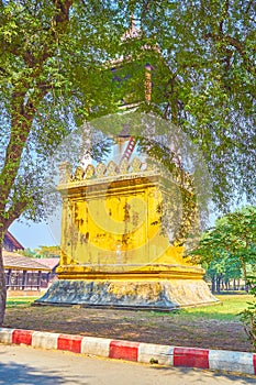 The clock tower among garden greenery in Mandalay Palace, Myanmar