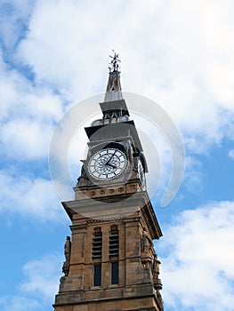 Clock tower of the historic victorian atkinson building in southport merseyside against a blue summer sky
