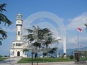 Clock tower and national flag of Georgia on the seafront in Batumi, Black Sea beach