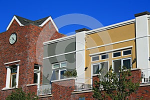 Clock Tower next to Modern Buildings