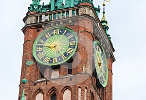 Clock tower of old historic brick town hall .