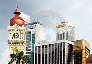 Clock tower of Sultan Abdul Samad building with modern buildings.