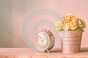 Clock and a vase of flowers.