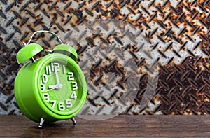 Clock on Wooden Floor with Steel Plat Grunge Background