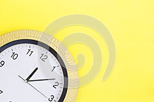 Clock on yellow background. Copy space.