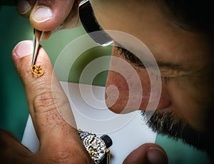 Clockmaker carefully repair antique precious wristwatch photo