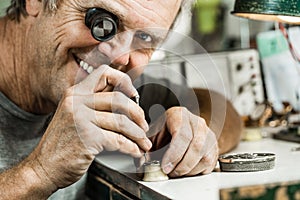 Clockmaker repairing wrist watch