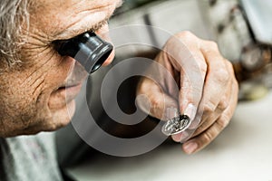Clockmaker repairing wrist watch