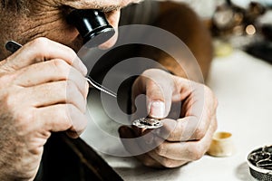 Clockmaker repairing wrist watch