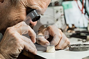 Clockmaker repairing wrist watch