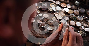 Clockmaker repairing wrist watch. Macro shot. Watchmaker hands repairing mechanism of old watch closeup.