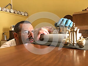 Clockmaker repairs clocks and watches  in his laboratory