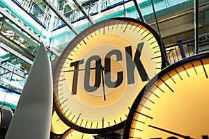 Clocks with inscriptions \'tik, tok and followed\'.Yellow and blue