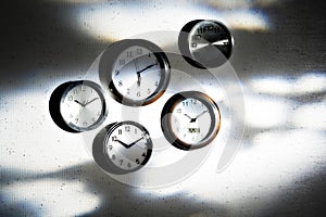 Clocks on shadowy wall photo