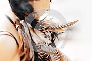 cloe up portrait of beautiful stylish woman with feathers in hair style