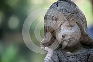 Cloes up photo of arden stone sculpture of a childern. Children statue.