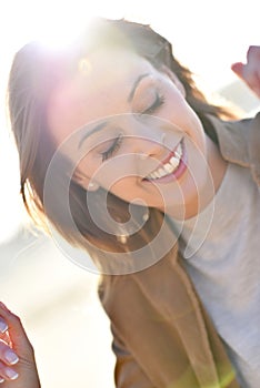 Cloesup of happy smiling woman in sunlight
