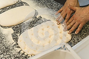 cloeup shot of chef& x27;s hands kneading pizza dough, pizza making concept photo