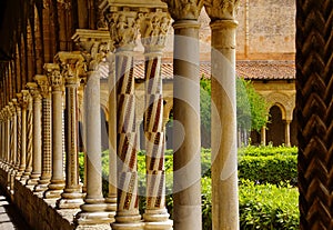 Cloister of the Benedictine monastery in the Cathedral of Monreale in Sicily. General view and details of the columns and capitals