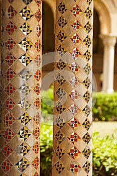 Cloister of the Benedictine monastery in the Cathedral of Monreale in Sicily. General view and details of the columns and capitals