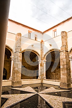 Cloister with cross of the Knights of Malta in the Castle of Crato in Flor da Rosa in Portugal photo