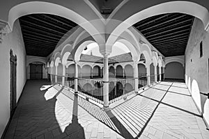 Cloister of medieval architecture with arches and columns around an outer courtyard, Andalucia, Spain.