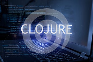 Clojure inscription against laptop and code background. Technology concept. Learn programming language