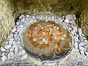 Money in a well at Clonmacnoise Monastery, County Offaly, Ireland photo